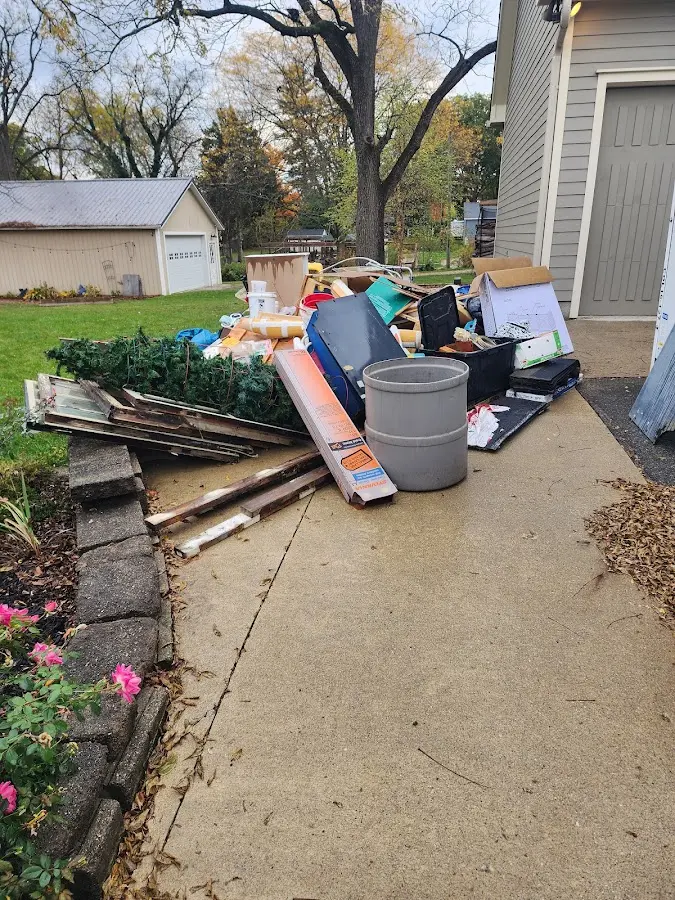 Dumpster being loaded with debris for Estate Cleanout Dumpster Rental in North Plains